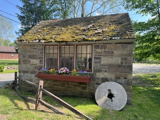 Small stone building with flowers.
