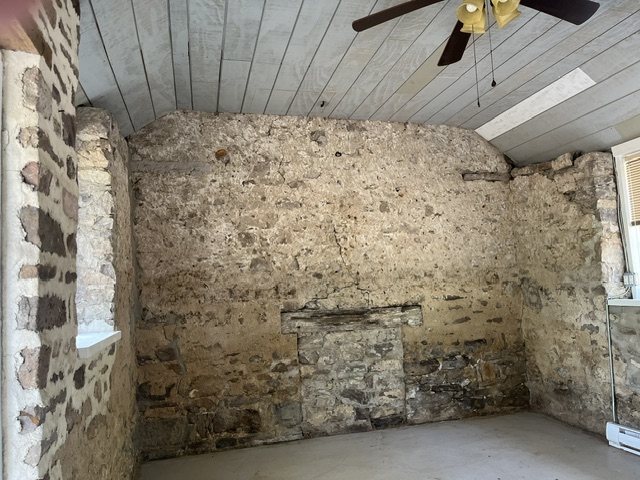 Interior of stone building towards short wall